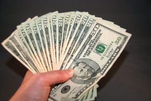 Large bills fanned out and held in hand